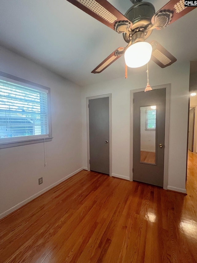 326 Nell St, Batesburg, SC 29006 - unfurnished bedroom with light wood-style flooring, baseboards, ceiling fan, and multiple windows
