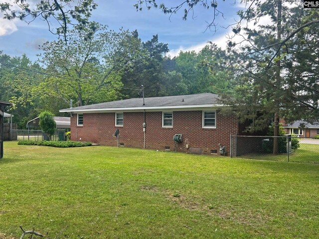 326 Nell St, Batesburg, SC 29006 - rear view of property featuring a lawn, crawl space, fence, and brick siding