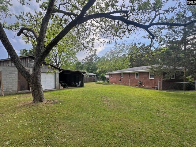 326 Nell St, Batesburg, SC 29006 - view of yard featuring fence, an outbuilding, and a garage