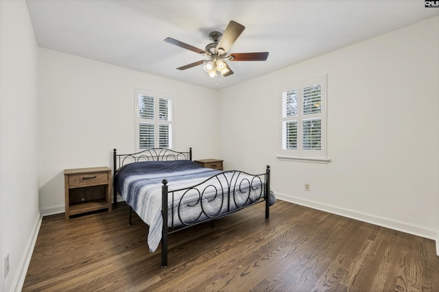 bedroom featuring wood finished floors, baseboards, and ceiling fan