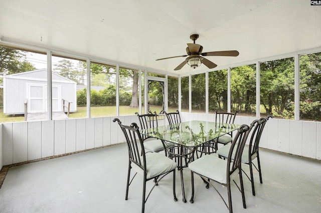 sunroom / solarium featuring a ceiling fan and outdoor dining area