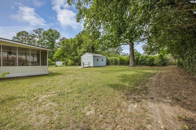 view of yard featuring an outbuilding, a sunroom, and a storage unit