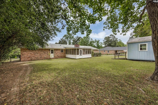view of yard with a sunroom and fence