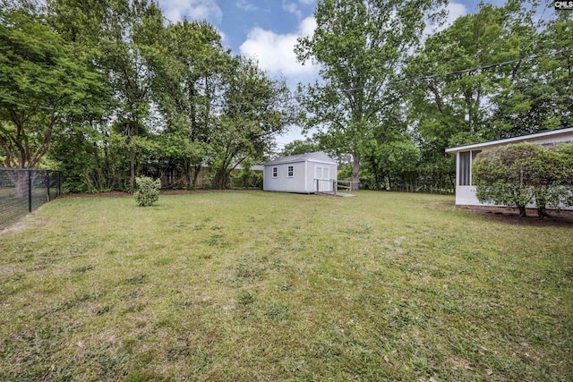 view of yard with an outdoor structure, a shed, and a fenced backyard
