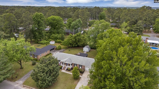 birds eye view of property with a view of trees