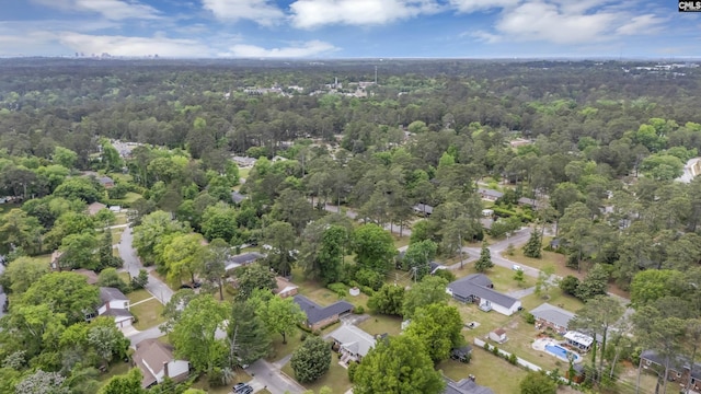 drone / aerial view featuring a wooded view