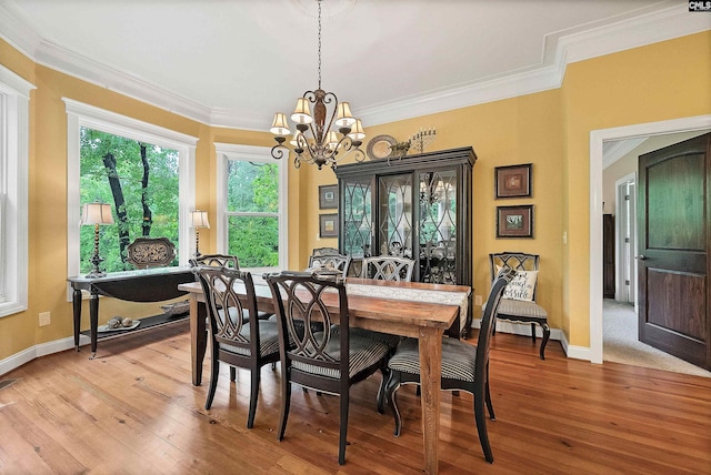1437 Heins Rd, Blythewood, SC 29016 - dining space featuring baseboards, crown molding, a chandelier, and light wood-style flooring
