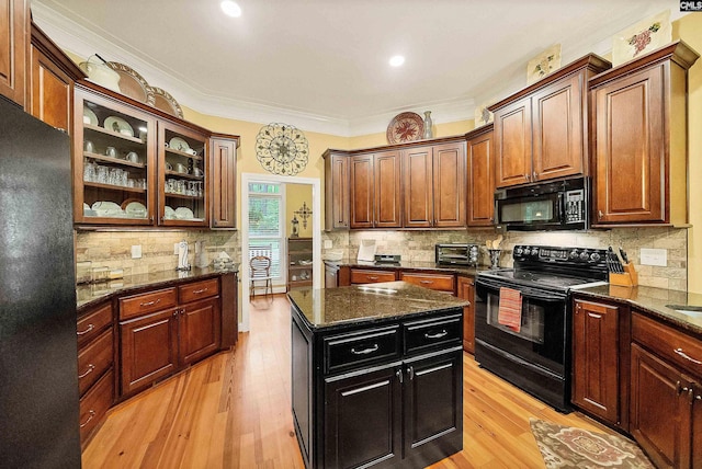 1437 Heins Rd, Blythewood, SC 29016 - kitchen with glass insert cabinets, black appliances, light wood finished floors, and tasteful backsplash