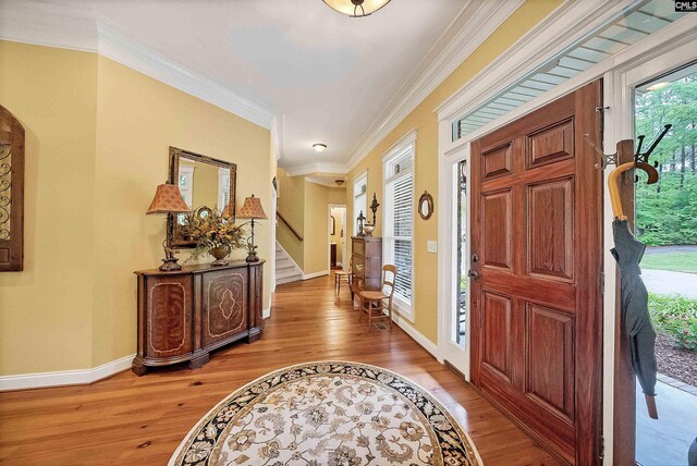 1437 Heins Rd, Blythewood, SC 29016 - entrance foyer featuring stairway, crown molding, arched walkways, light wood-style flooring, and baseboards