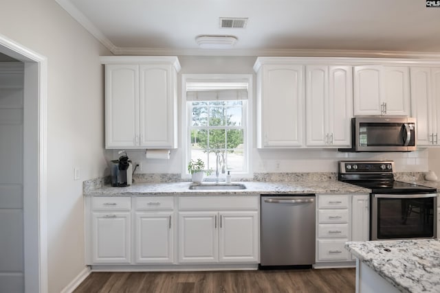 kitchen with white cabinets, dark wood-style flooring, stainless steel appliances, and a sink