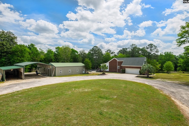 view of front of home featuring driveway, a front yard, and a carport