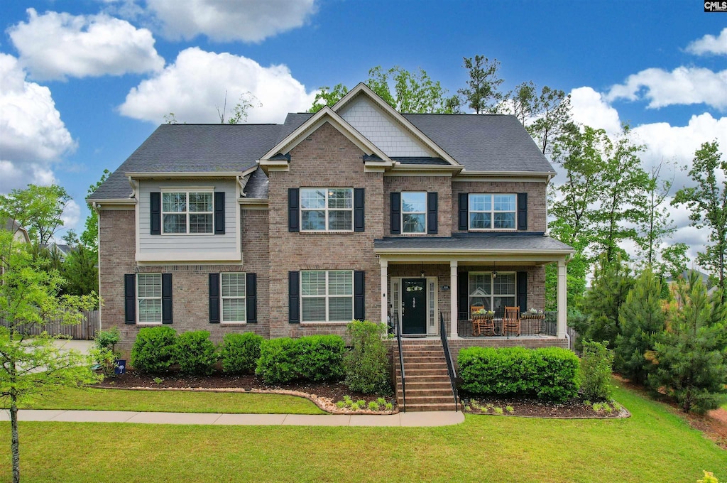 590 Wild Hickory Ln, Blythewood, SC 29016 - view of front of property with covered porch, brick siding, a front lawn, and stairs