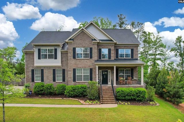 590 Wild Hickory Ln, Blythewood, SC 29016 - view of front of property with covered porch, brick siding, a front lawn, and stairs
