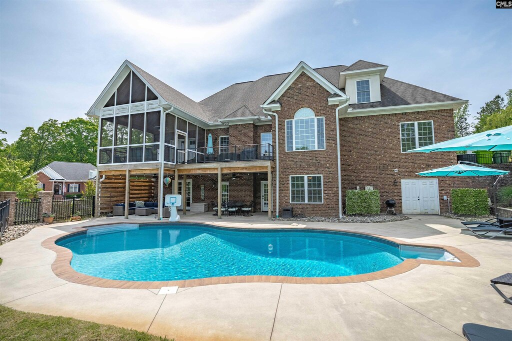 402 Holly Berry Cir, Blythewood, SC 29016 - view of pool with a fenced in pool, fence, a sunroom, and a patio area