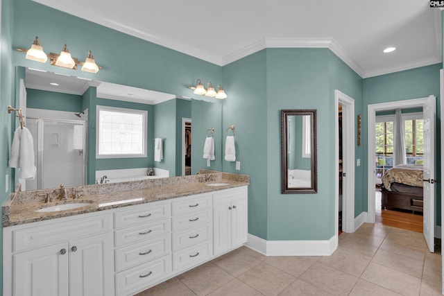full bath with a stall shower, baseboards, tile patterned flooring, and a sink