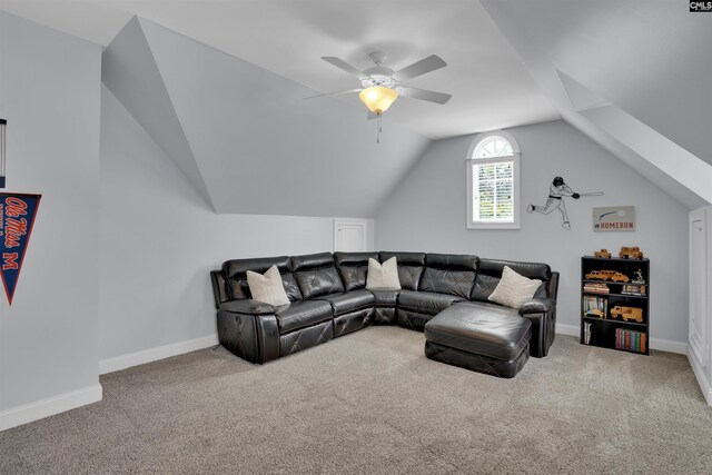 living area with carpet flooring, baseboards, ceiling fan, and lofted ceiling