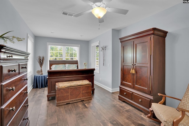 bedroom featuring visible vents, ceiling fan, dark wood-style floors, and baseboards