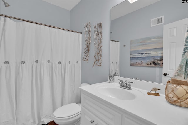 bathroom featuring visible vents, toilet, and vanity