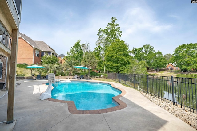 view of swimming pool featuring fence, a fenced in pool, and a patio area