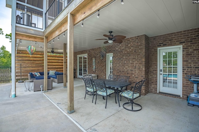 view of patio featuring fence, a ceiling fan, an outdoor living space, and outdoor dining area