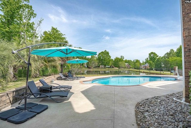 view of swimming pool with a patio, fence, and a fenced in pool