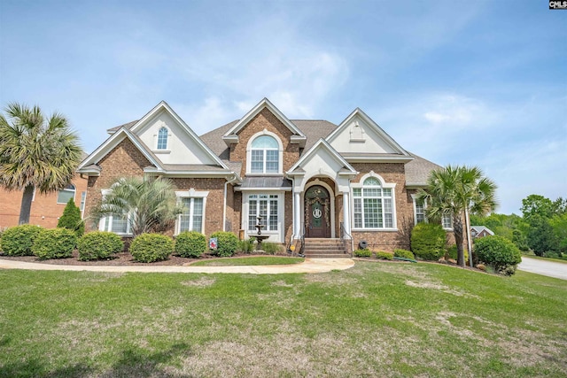 craftsman inspired home with brick siding and a front lawn