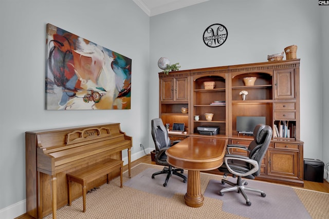home office with baseboards, wood finished floors, and crown molding