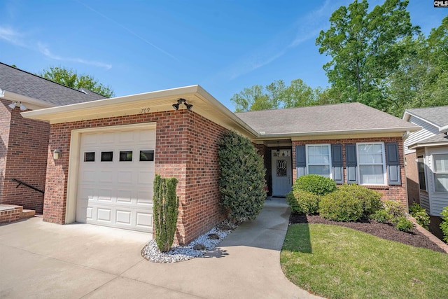 single story home featuring a garage, brick siding, a shingled roof, and concrete driveway