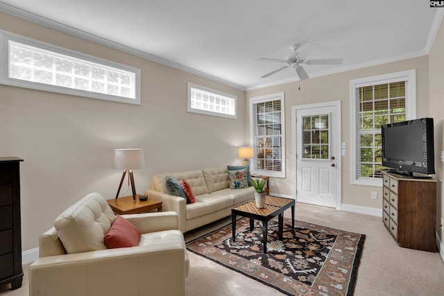 carpeted living room featuring a ceiling fan, crown molding, and baseboards