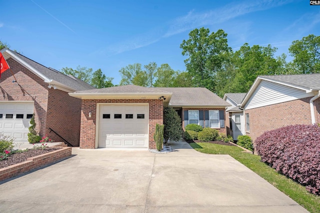 ranch-style house with concrete driveway, brick siding, and a garage