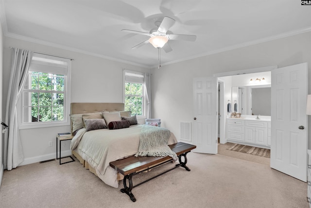 bedroom featuring ensuite bath, ornamental molding, light carpet, a sink, and visible vents