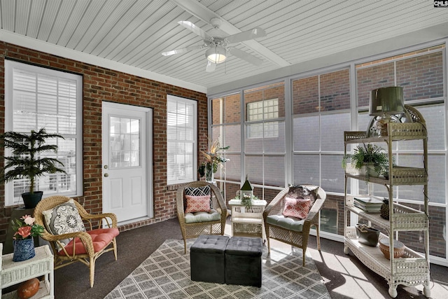 sunroom / solarium with brick wall and carpet flooring
