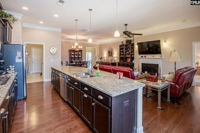 kitchen with a sink, visible vents, open floor plan, dark wood finished floors, and ceiling fan with notable chandelier