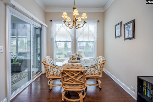 dining space featuring ornamental molding, an inviting chandelier, wood finished floors, and baseboards