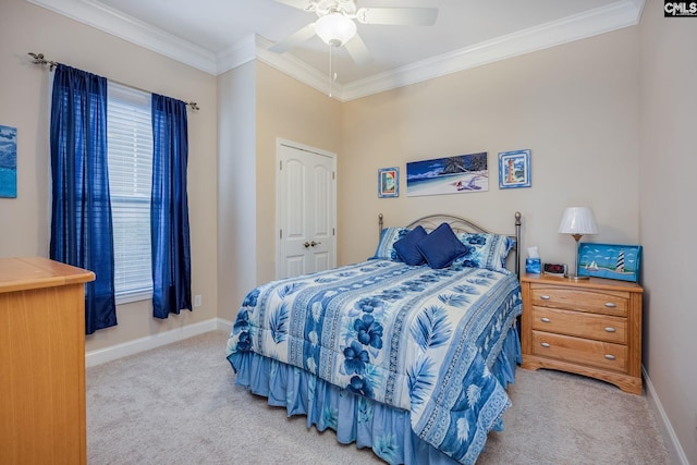 carpeted bedroom featuring baseboards, ornamental molding, and ceiling fan