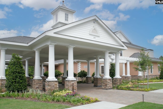 view of front of property with stone siding, a porch, and a pergola
