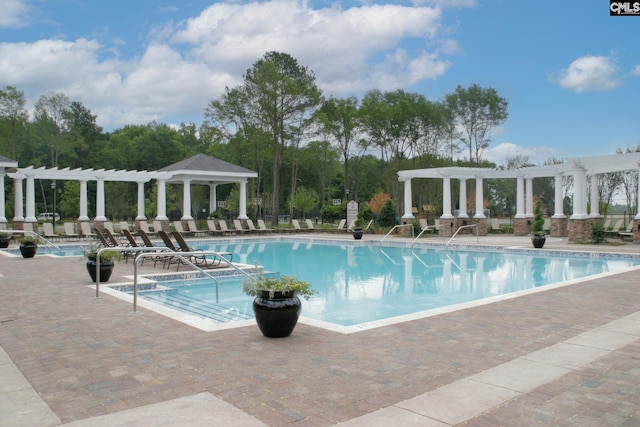 community pool featuring a pergola and a patio area