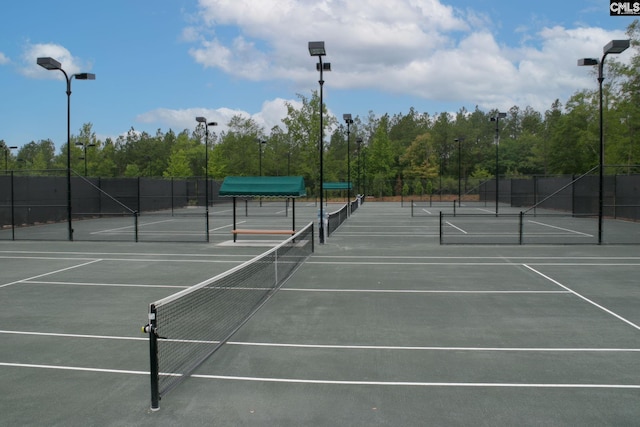 view of tennis court with fence