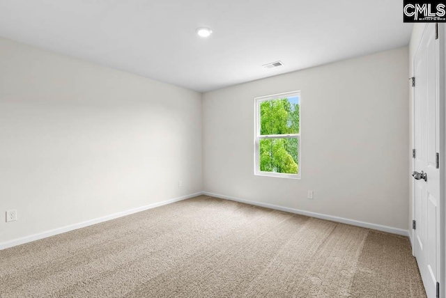 spare room featuring baseboards, visible vents, carpet floors, and recessed lighting