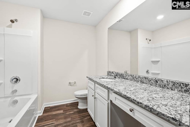 bathroom with wood finished floors, toilet, shower / tub combination, baseboards, and visible vents