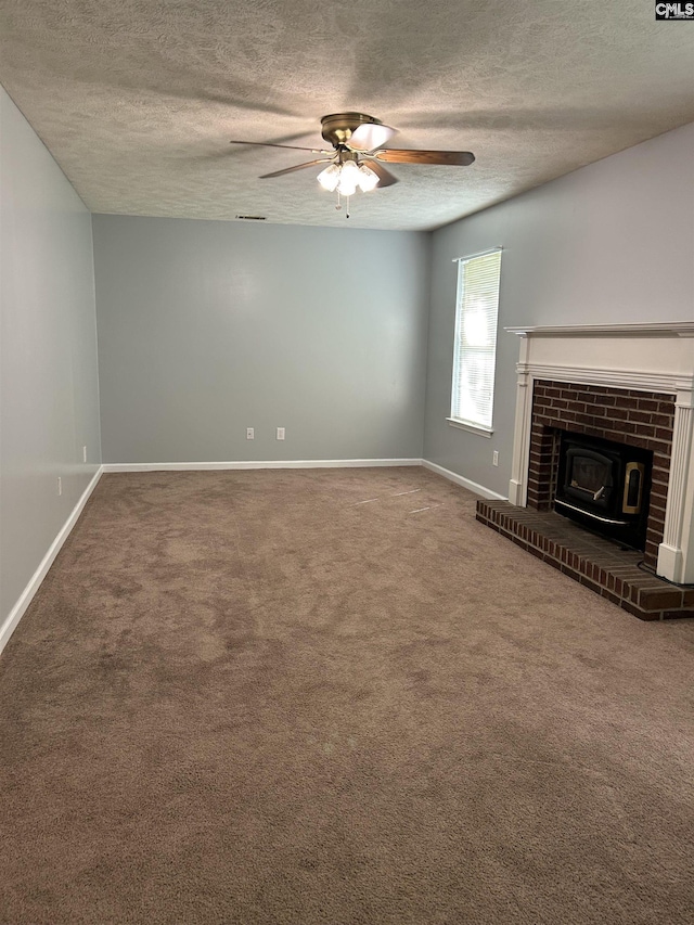 unfurnished living room with carpet floors, a textured ceiling, ceiling fan, and baseboards
