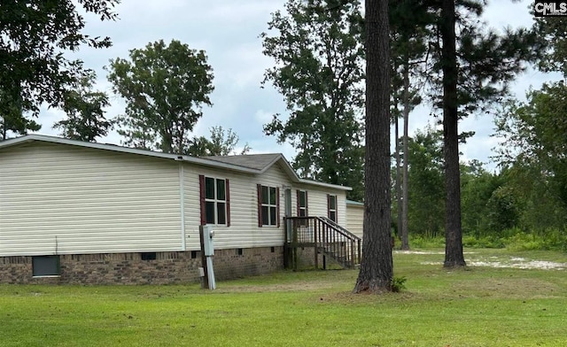 view of home's exterior featuring a lawn and crawl space