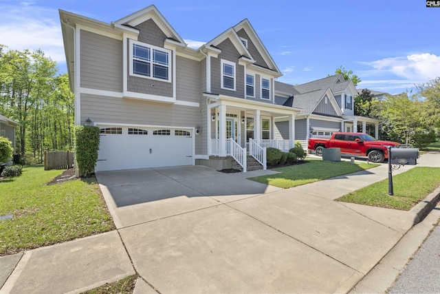 craftsman house featuring a porch, a front yard, concrete driveway, and an attached garage