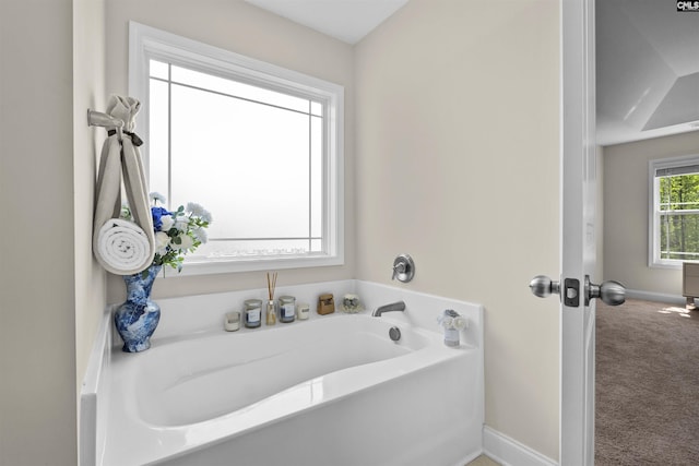 bathroom featuring baseboards and a garden tub