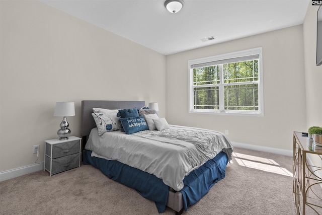 bedroom featuring baseboards, visible vents, and carpet