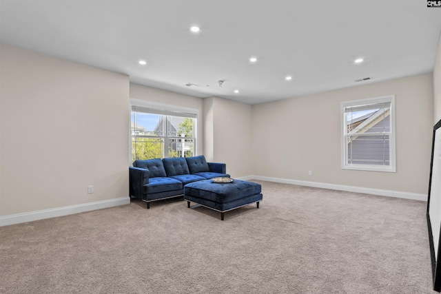 living room with recessed lighting, carpet floors, and plenty of natural light