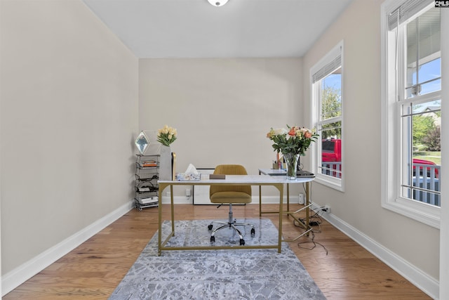 office featuring baseboards and wood finished floors