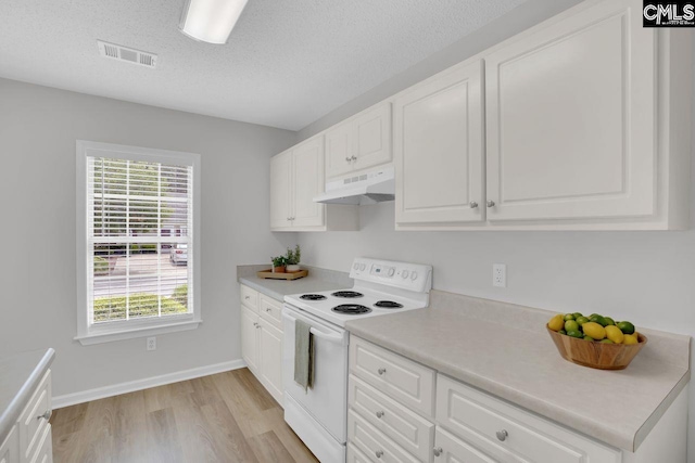 kitchen featuring white electric range oven, white cabinets, visible vents, under cabinet range hood, and light wood-type flooring