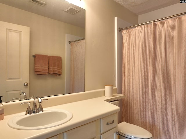 900 Taylor St Unit 304, Columbia, SC 29201 - bathroom with toilet, a textured ceiling, visible vents, and vanity