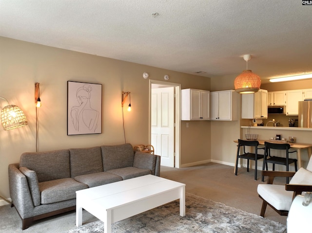 900 Taylor St Unit 304, Columbia, SC 29201 - living room featuring baseboards, a textured ceiling, and light colored carpet